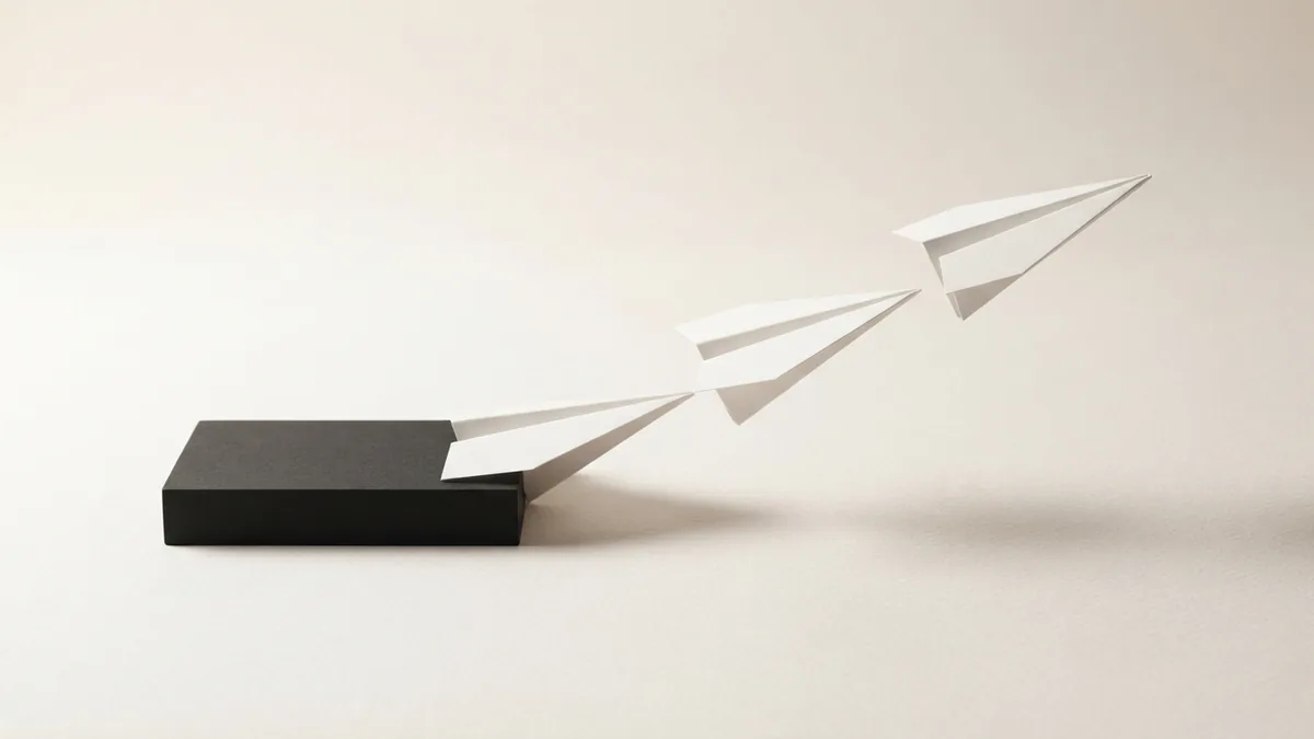 Layered paper planes and a threshold block showing VAT registration steps